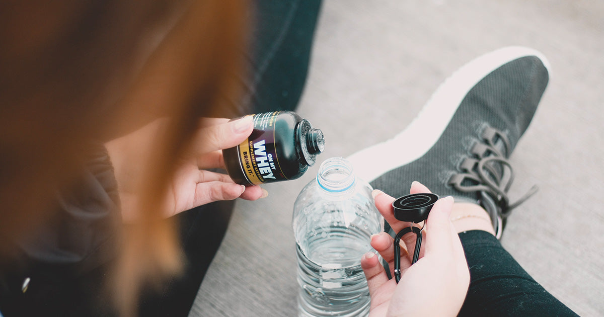 Woman Funneling OnMyWhey Into Water Bottle